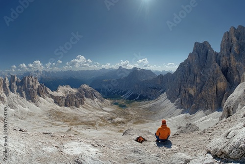 A camper enjoys sunrise views over the Dolomites mountains in Italy during su...