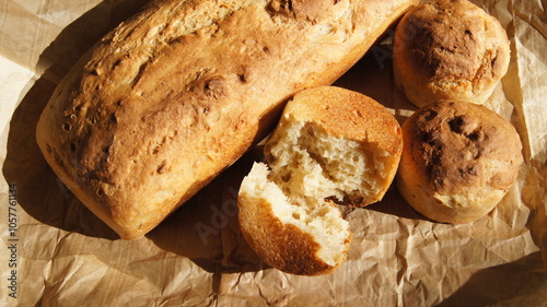 Bread, golden crust of bread, broken bread, different shapes on food paper, homemade baking, made of white flour of durum wheat, yeast baking, bread texture, Italy