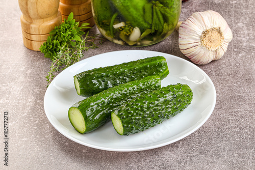 Homemade lighty salted cucumbers with herbs photo