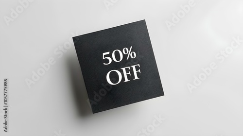 White '50% OFF' Text on a Anthracite Square Paper Note. White Background with Copy Space