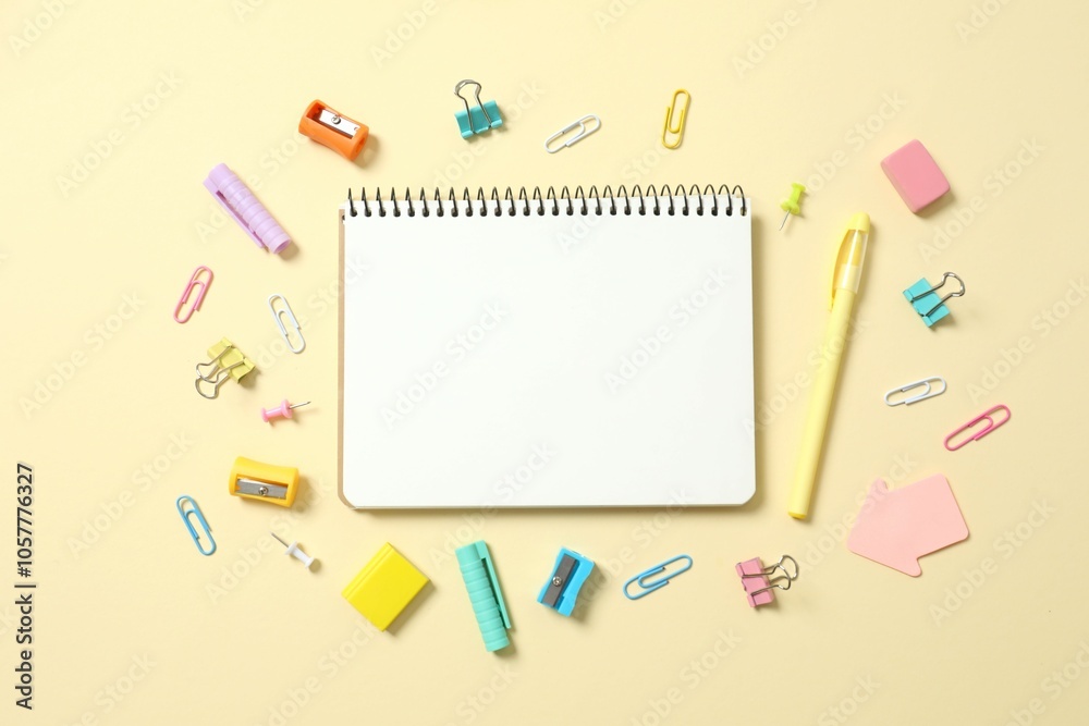 Flat lay with colorful school stationery and notebook on color background, top view Flat lay with colorful school stationery and notebook on color background, top view