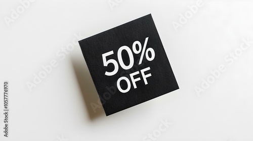 White '50% OFF' Text on a Black Square Paper Note. White Background with Copy Space