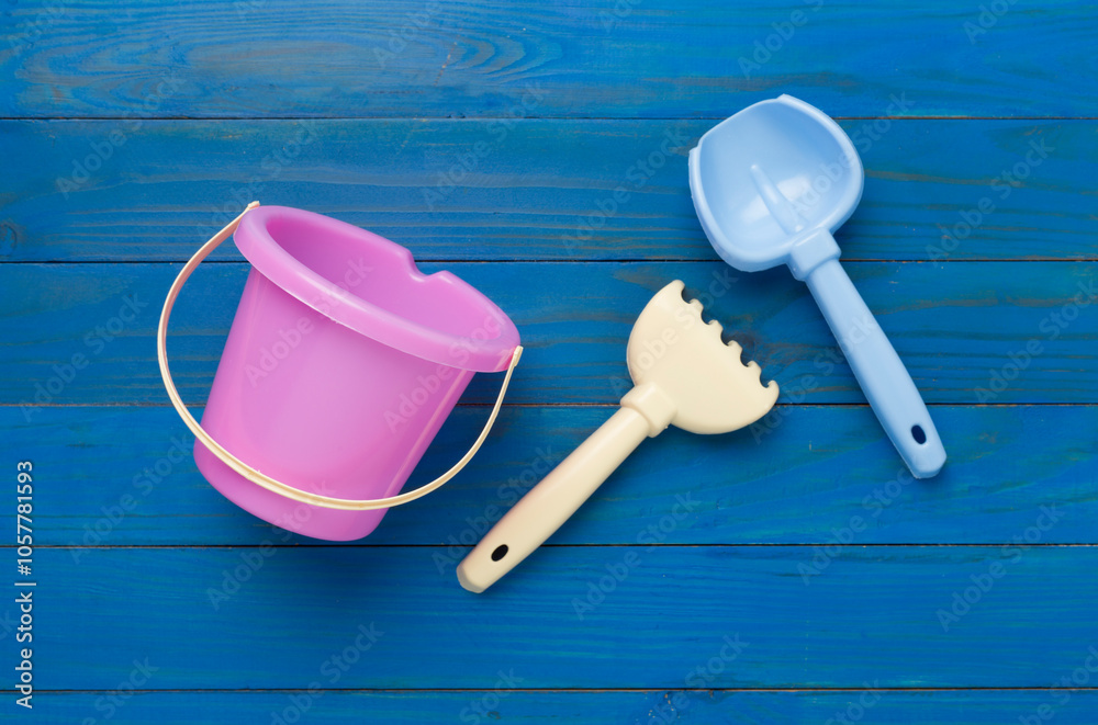Cute toys for playing with sand on wooden background, top view Cute toys for playing with sand on wooden background, top view