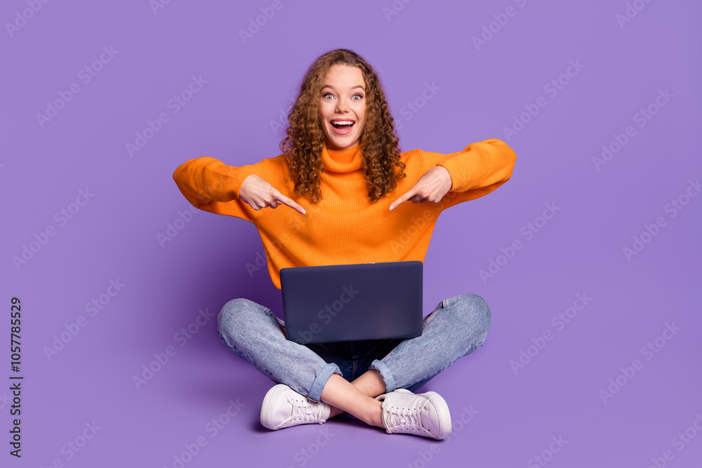 Full length portrait of lovely young girl point fingers netbook wear sweater isolated on purple color background Full length portrait of lovely young girl point fingers netbook wear sweater isolated on purple color background