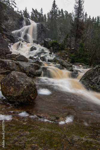 Landscape shot of a large waterfall in the forest and nature. Autumn landscape The Elgafossen Vattenfall river provides a natural border between Sweden and Norway at Vassbotten, Scandinavia photo