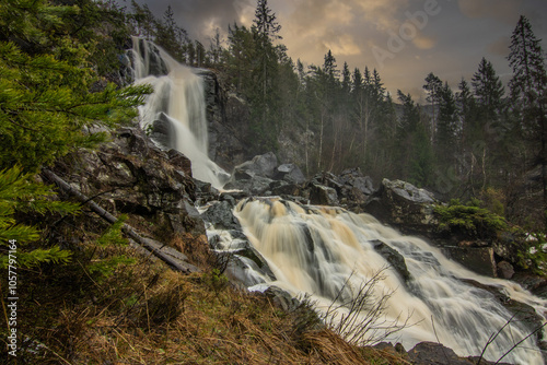 Landscape shot of a large waterfall in the forest and nature. Autumn landscape The Elgafossen Vattenfall river provides a natural border between Sweden and Norway at Vassbotten, Scandinavia photo