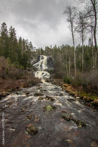 Landscape shot of a large waterfall in the forest and nature. Autumn landscape The Elgafossen Vattenfall river provides a natural border between Sweden and Norway at Vassbotten, Scandinavia photo