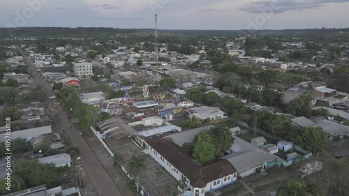 Drone hovers over center of town at sunset near small amusement park in Oiapoque, Amapá, Brazil photo