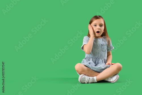 Shocked little girl sitting...