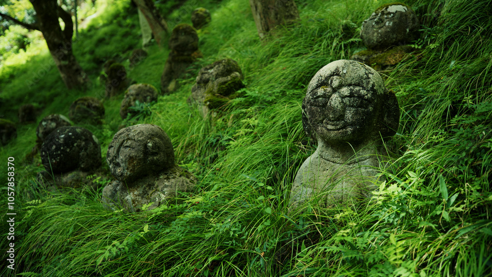 Small Japanese statues on grassy hillside Small Japanese statues on grassy hillside