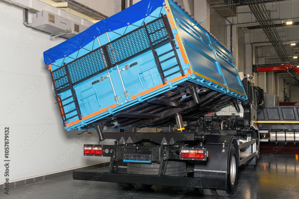 Blue metal semitrailer grain truck for transporting bulk materials.