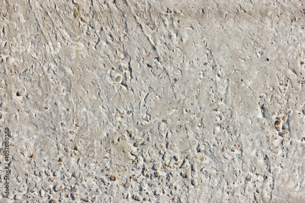 Concrete texture with small holes and irregular surface, perfect for backgrounds and design projects, construction material concept