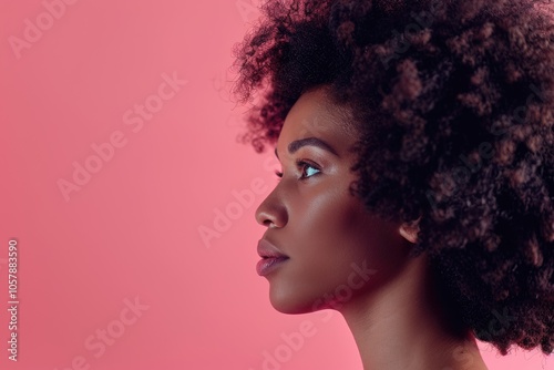 Stunning afro woman profile photo on bright pink background.