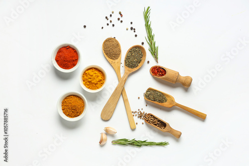 Fototapeta Naklejka Na Ścianę i Meble -  Composition with aromatic spices and fresh rosemary on light background