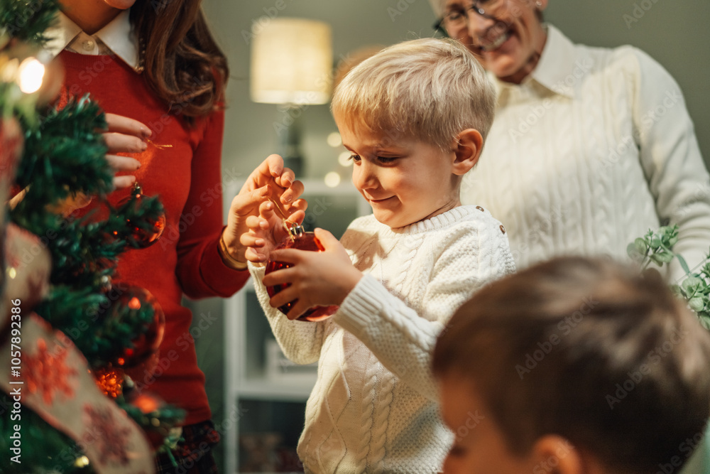 Happy family is decorating christmas tree at home Happy family is decorating christmas tree at home
