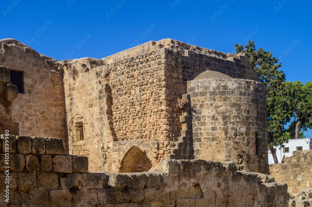 Ancient ruins adorned with stones under a brilliant blue sky at a historical site in Cyprus Ancient ruins adorned with stones under a brilliant blue sky at a historical site in Cyprus