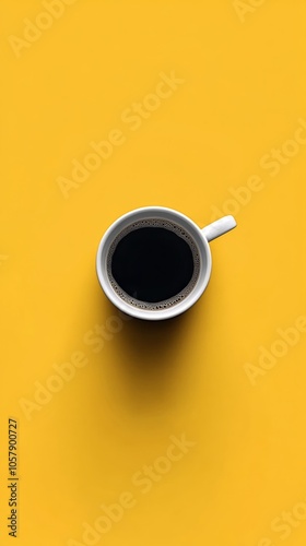 A steaming cup of black coffee on a bright yellow background in a cozy setting
