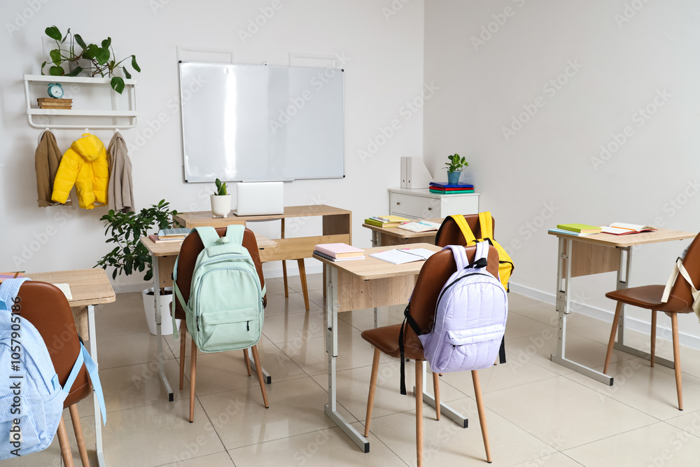 Interior of empty classroom with school desks