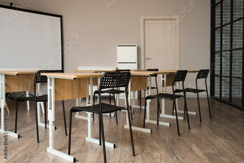 Interior of classroom with school desks and projector screen