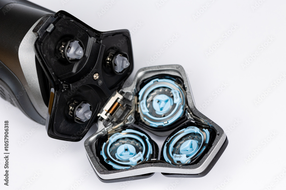 Beard electric shaver on a white background. Inside view of the cutting blades . Photo taken in artificial light with clearly visible details of the shaver