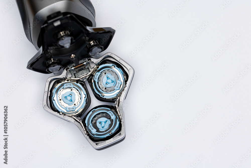 Beard electric shaver on a white background. Inside view of the cutting blades . Photo taken in artificial light with clearly visible details of the shaver