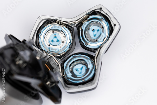 Obraz na płótnie Beard electric shaver on a white background. Inside view of the cutting blades . Photo taken in artificial light with clearly visible details of the shaver w salonie