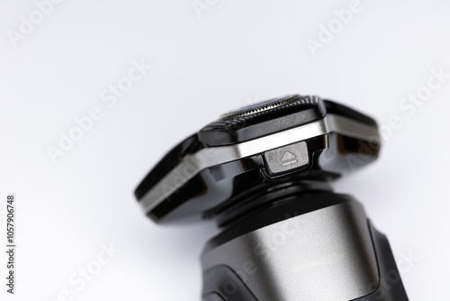 Obraz na płótnie Beard electric shaver on a white background. Close-up of the cutting blades. Photo taken in artificial light with clearly visible details of the shaver w salonie