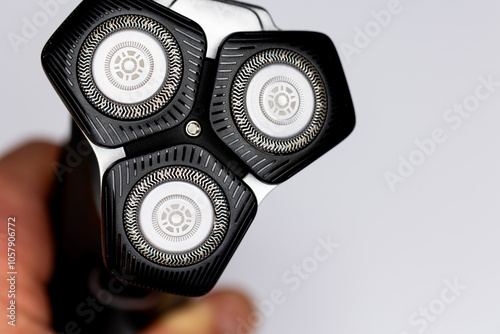 Obraz na płótnie Beard electric shaver on a white background. Close-up of the cutting blades. Photo taken in artificial light with clearly visible details of the shaver w salonie