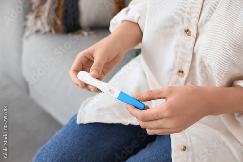 Pregnant woman with positive pregnancy test. Closeup