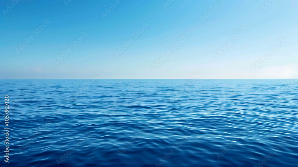 Obraz premium Deep blue ocean with a clear blue sky. The water is calm and there are no waves. The horizon is in the distance.