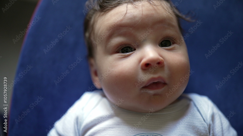 Close-up of baby looking directly at the camera with wide curious eyes, observing the surroundings, calm and inquisitive expression, capturing early development and baby’s attention Close-up of baby looking directly at the camera with wide curious eyes, observing the surroundings, calm and inquisitive expression, capturing early development and baby’s attention