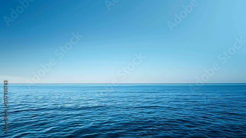 Deep blue ocean with a clear blue sky. The water is calm and there are no waves. The horizon is in the distance.