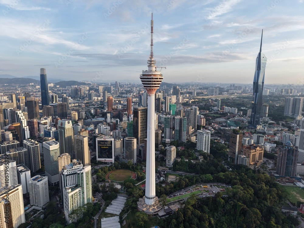 Obraz premium KL Tower in Kuala Lumpur - Aerial drone view of the iconic observation tower in SE Asia. The Exchange 106 building is to the left and Merdeka 118 to the right. Taken October 28, 2024 in Kuala Lumpur.