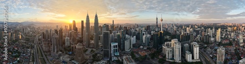 Photography Wide aerial panorama view of Kuala Lumpur skyline with sun shining from behind buildings