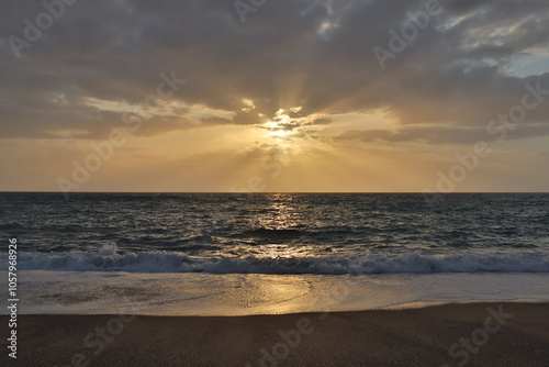 Fototapeta Naklejka Na Ścianę i Meble -  Seascape clouds at sunset over the sea on the beach