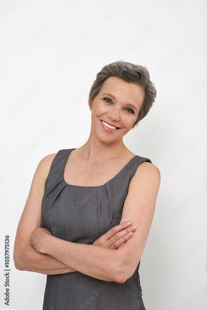 Portrait, happy and mature businesswoman with arms crossed in studio for job on white background. Face, smile and confident creative manager, professional and public relations expert in New Zealand Portrait, happy and mature businesswoman with arms crossed in studio for job on white background. Face, smile and confident creative manager, professional and public relations expert in New Zealand