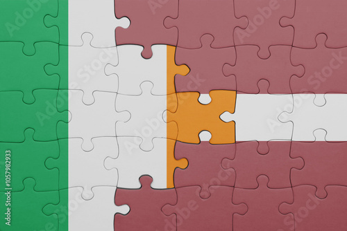 puzzle with the colourful national flag of ireland and flag of latvia .