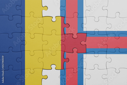 puzzle with the colourful national flag of romania and flag of faroe islands .