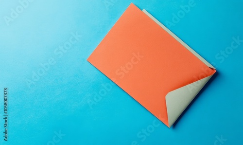 An overhead view features an orange sheet of paper placed diagonally on a blue surface. The paper displays a handwritten message advocating for equal pay