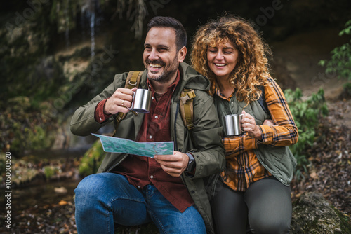 couple hiker backpacker hold map and cup find route on map