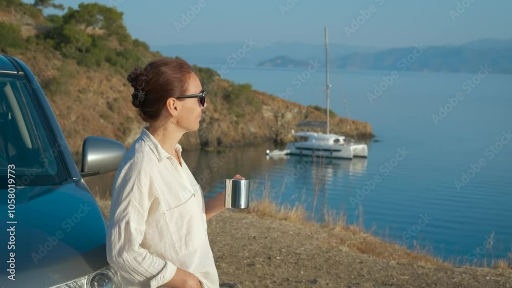 Carefree lady with car at sea landscape. A view of cute female enjoy the sea landscape with coffee in the morning sun light. Carefree lady with car at sea landscape. A view of cute female enjoy the sea landscape with coffee in the morning sun light.
