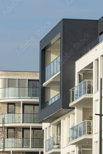 Graphic architectural detail of exterior luxury apartment facade in contemporary architecture Dutch design against a clear blue sky