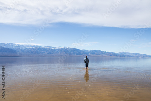 Man standing in Lake Manly at Badwater Basin in Death Valley National Park, California