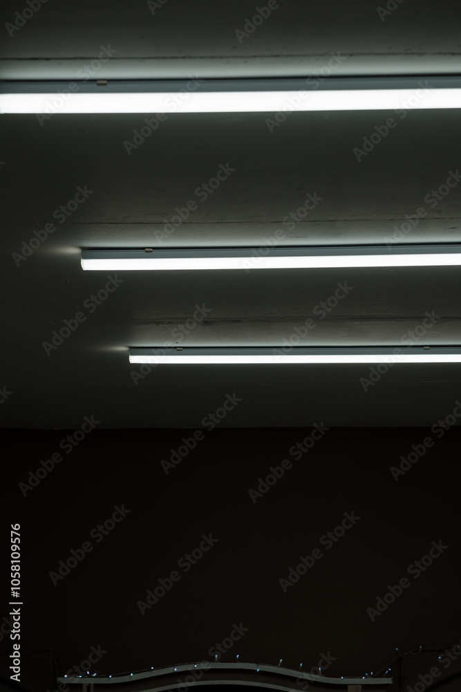 Modern Minimalist Ceiling with Fluorescent Lights in a Dimly Lit Room Modern Minimalist Ceiling with Fluorescent Lights in a Dimly Lit Room