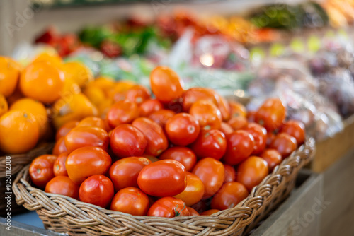 Eco products store counter with large assortment of fresh tomatoes for salent photo