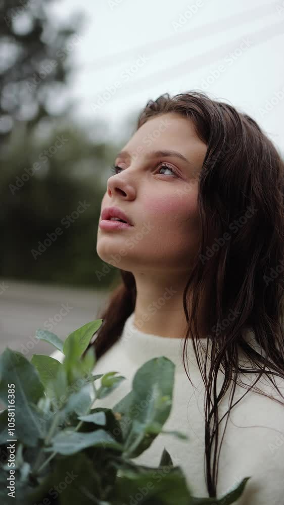 Vertical video, portrait of a beautiful girl holding a bouquet of eucalyptus trees, ikebana, florist, aroma, nature and care, details, freshness, air, rain, wet hair, greens and leaves, face Vertical video, portrait of a beautiful girl holding a bouquet of eucalyptus trees, ikebana, florist, aroma, nature and care, details, freshness, air, rain, wet hair, greens and leaves, face