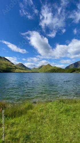 Wallpaper Mural Scenic view of Moke Lake among the valley in Queenstown, New Zealand. Landscape with lake, mountains and blue sky with clouds  Torontodigital.ca