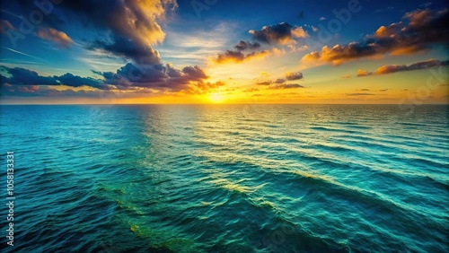 Deep blues and greens blend into the horizon as the sun sets over a vast expanse of ocean waves, peaceful ocean, nature landscape, beachscape, sea horizon