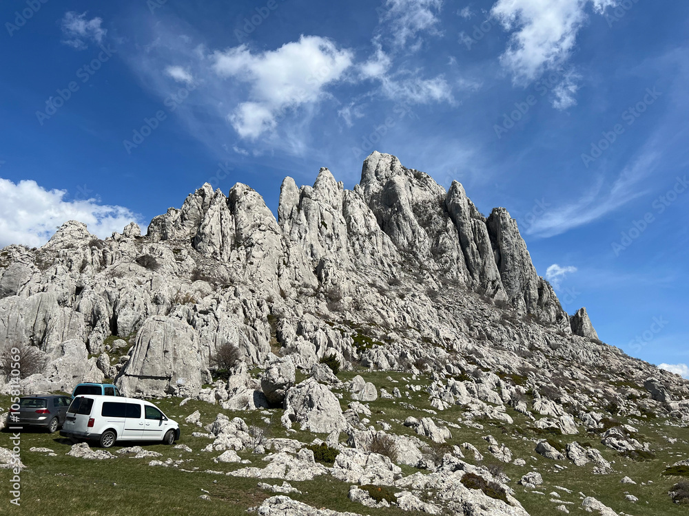 Fototapeta premium Rocky ridge of Tulove grede or karst mountain peak of Tulovice - Velebit Nature Park, Croatia (Stjenoviti greben Tulove grede ili krški planinski vrh Tulovice - Park prirode Velebit, Hrvatska)