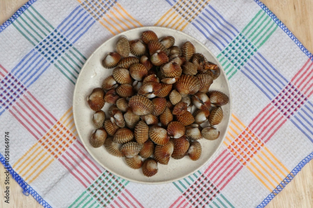 Sweet seafood blood clams served on a plate top view Sweet seafood blood clams served on a plate top view